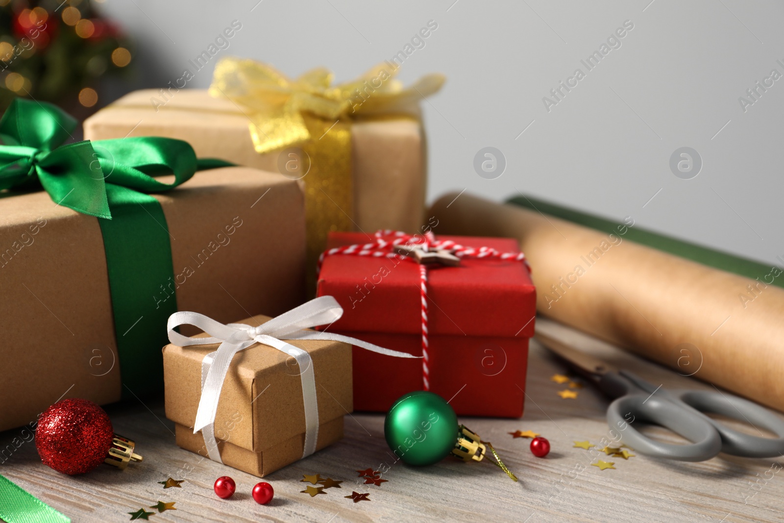 Photo of Beautiful gift boxes and Christmas decorations on white wooden table