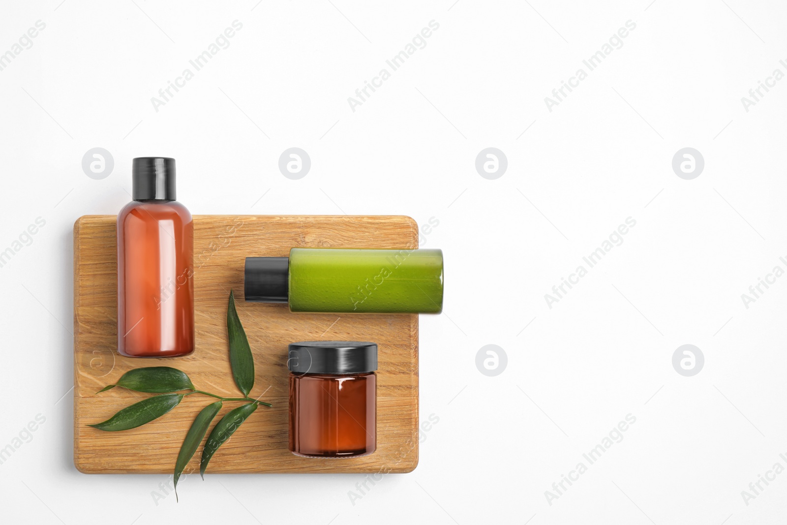 Photo of Bottles with cosmetic products isolated on white, top view. Spa treatment