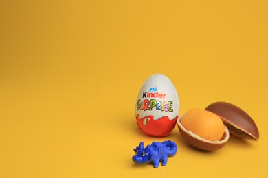 Sveti Vlas, Bulgaria - July 3, 2023: Kinder Surprise Eggs, plastic capsule and toy on yellow background, space for text