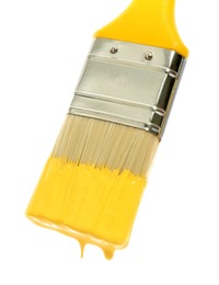 Photo of Brush with yellow paint on white background