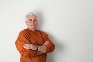 Photo of Portrait of handsome mature man on light background. Space for text