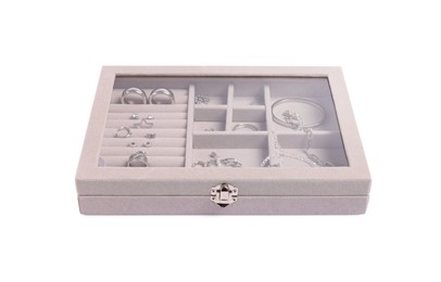 Photo of Jewelry box with many different silver accessories isolated on white