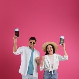 Couple of tourists with tickets and passports on pink background