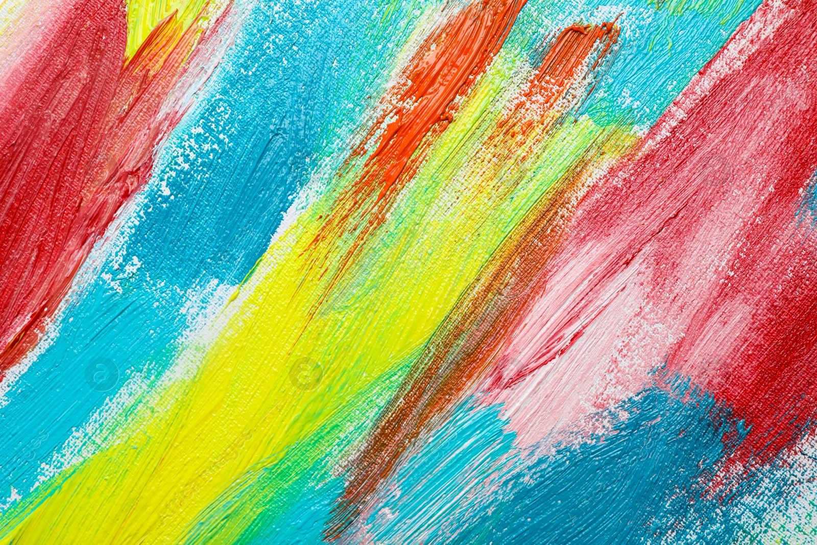 Photo of Strokes of colorful acrylic paints on canvas, closeup