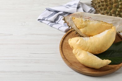 Fresh ripe durians on white wooden table. Space for text