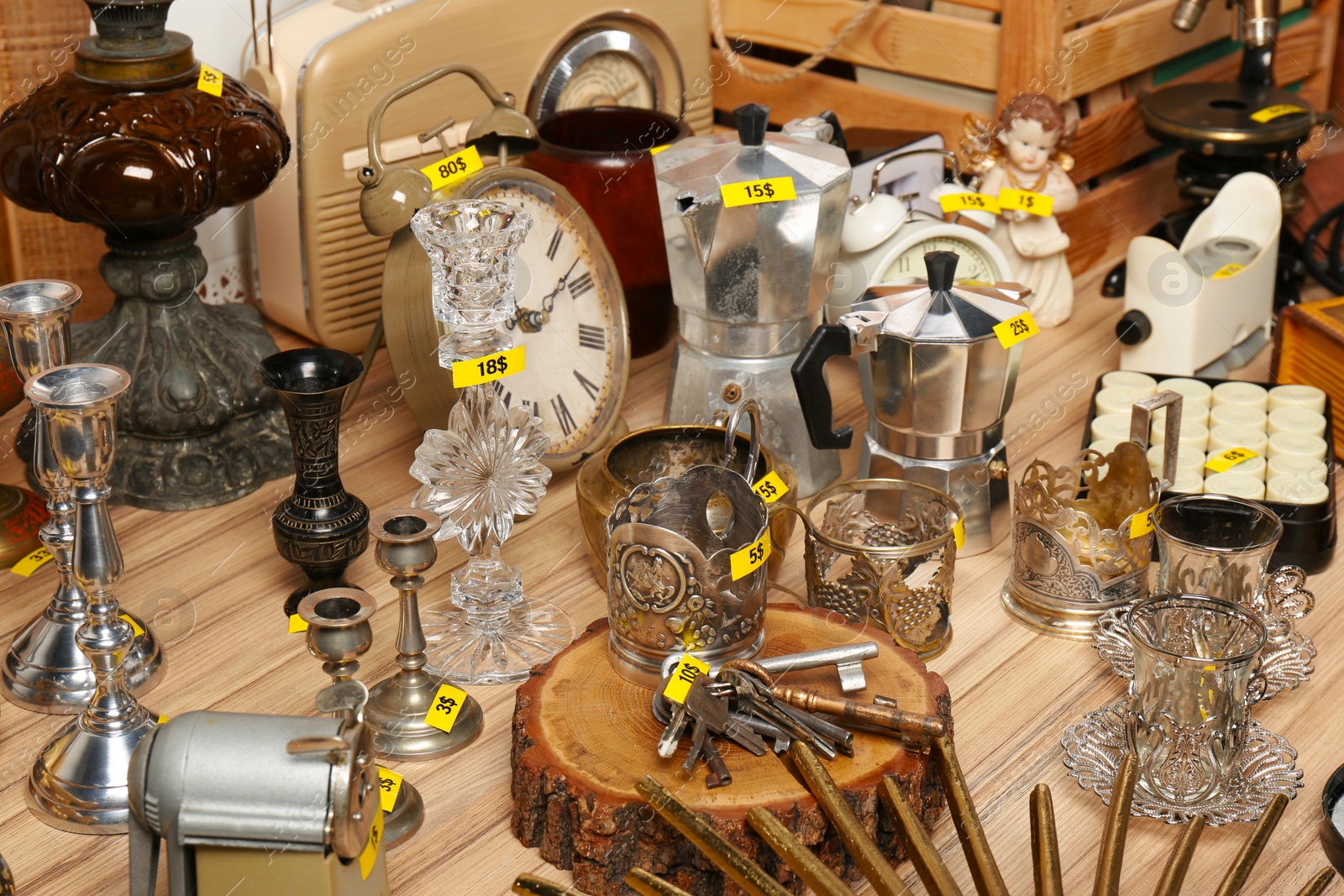 Photo of Many different items on wooden table. Garage sale