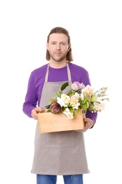 Male florist holding basket with flowers on white background