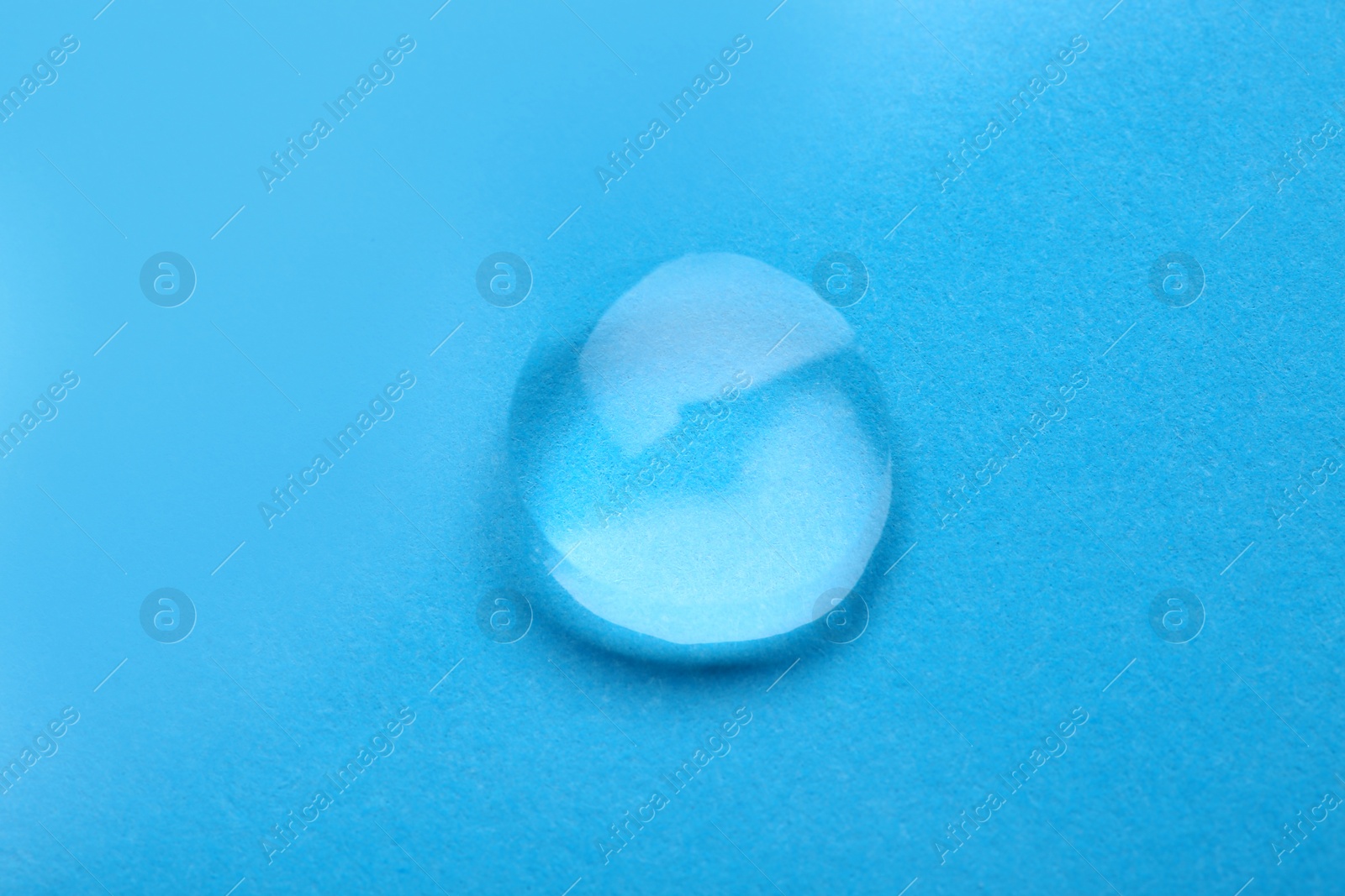 Photo of Water drop on color background, top view