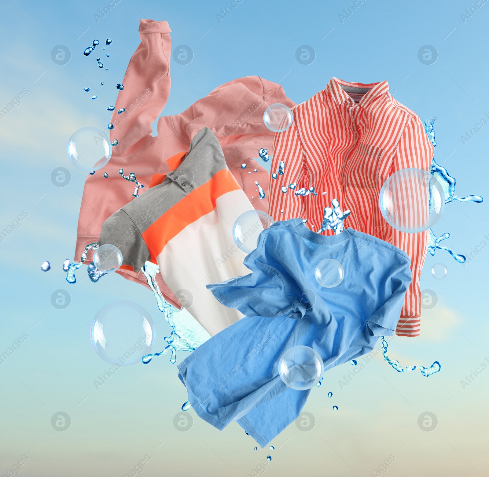 Image of Washing powder bubbles and clothes in blue sky