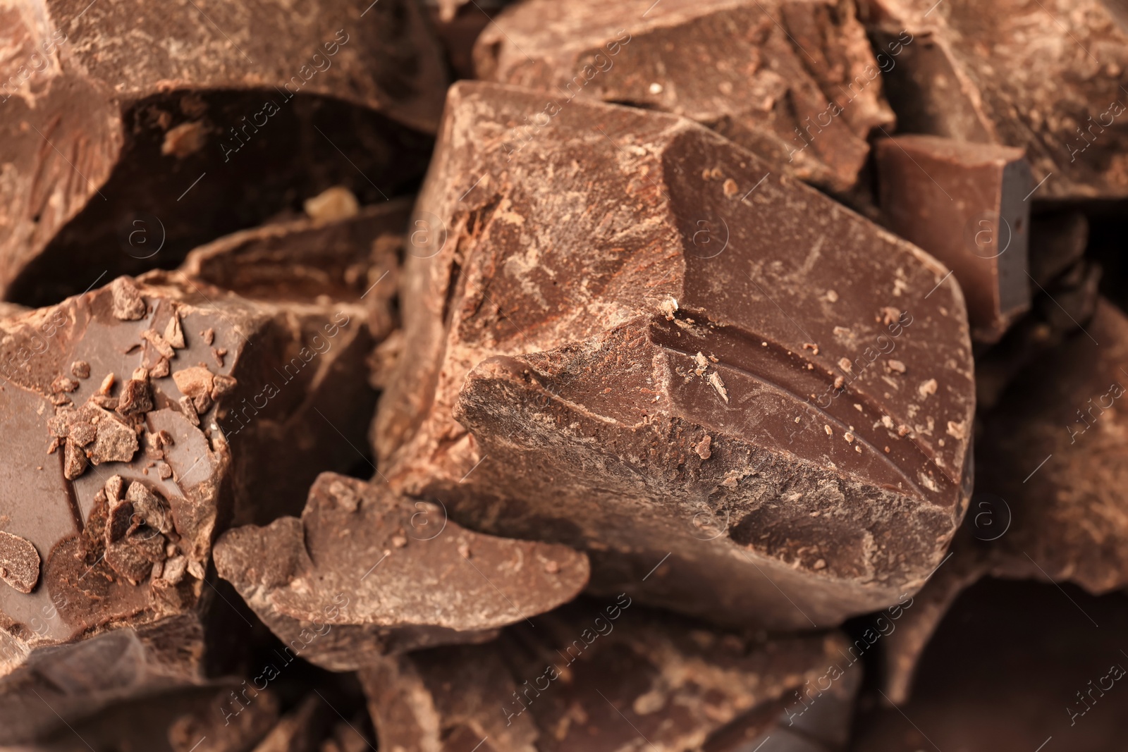 Photo of Delicious black chocolate chunks, closeup