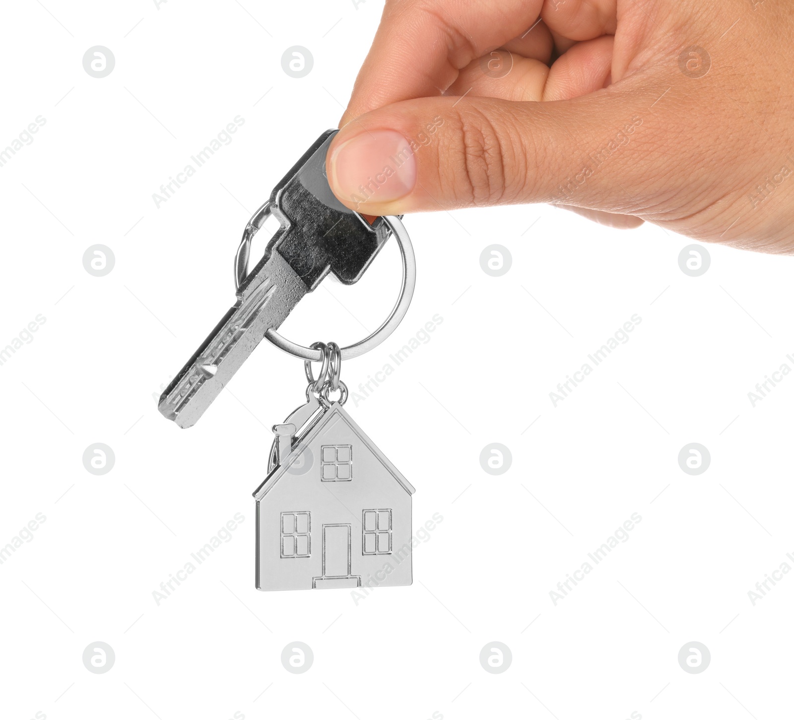 Photo of Woman holding key with metallic keychain in shape of house on white background, closeup