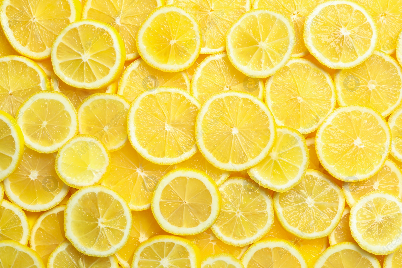 Photo of Many fresh juicy lemon slices as background, top view