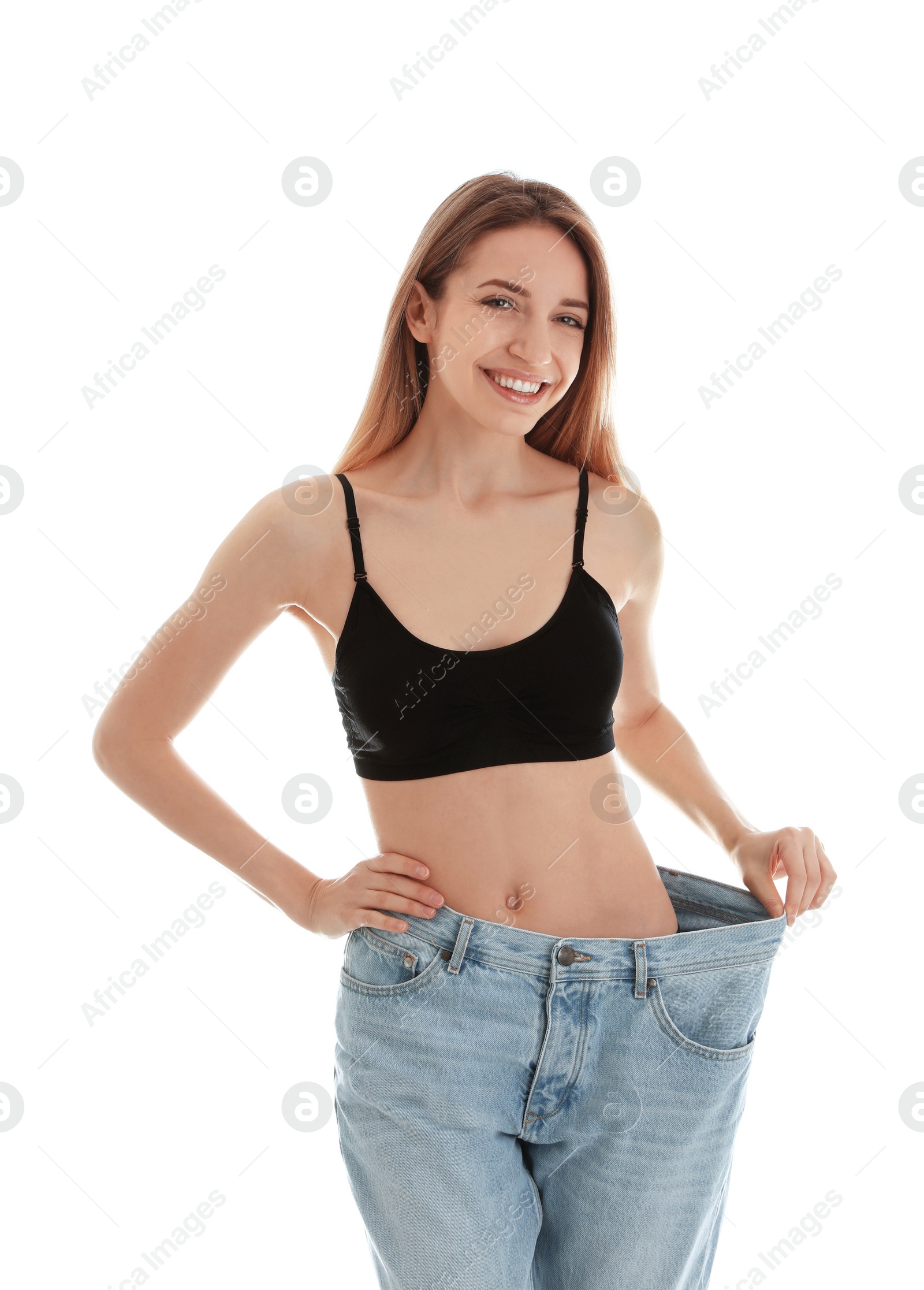 Photo of Slim woman in oversized jeans on white background. Perfect body