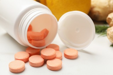 Photo of Dietary supplements in plastic bottle on white table, closeup