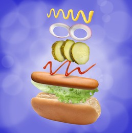Image of Hot dog ingredients in air on blue background