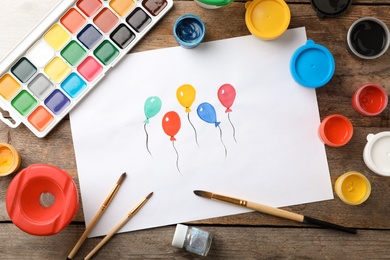 Photo of Flat lay composition with child's painting of balloons on table