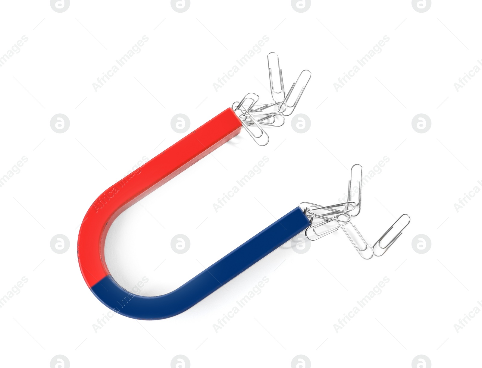 Photo of Magnet attracting paper clips on white background, top view