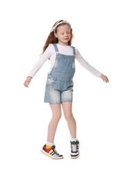 Photo of Cute little girl dancing on white background