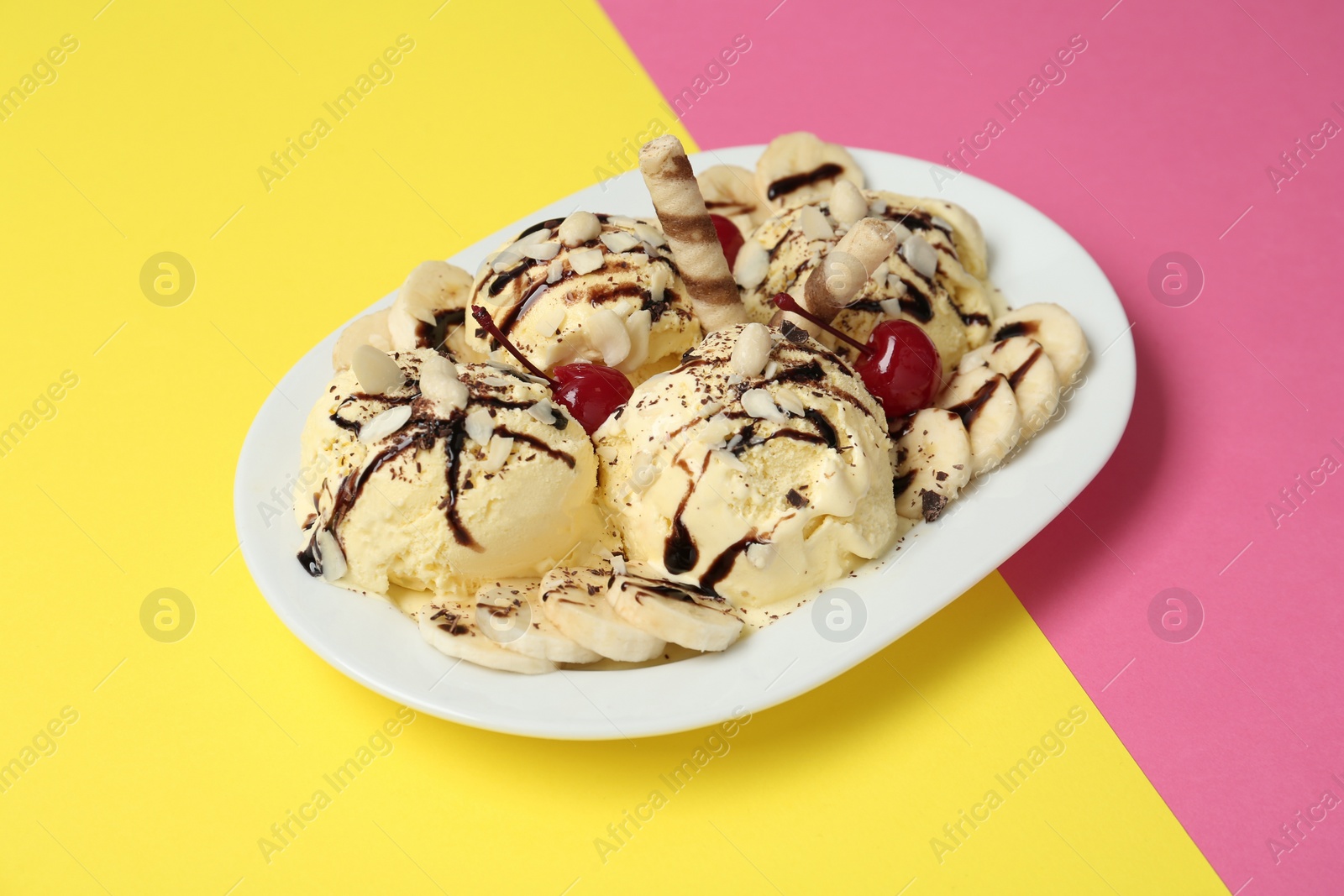 Photo of Delicious dessert with banana ice cream on color background