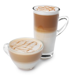 Glass cups of tasty caramel macchiato on white background