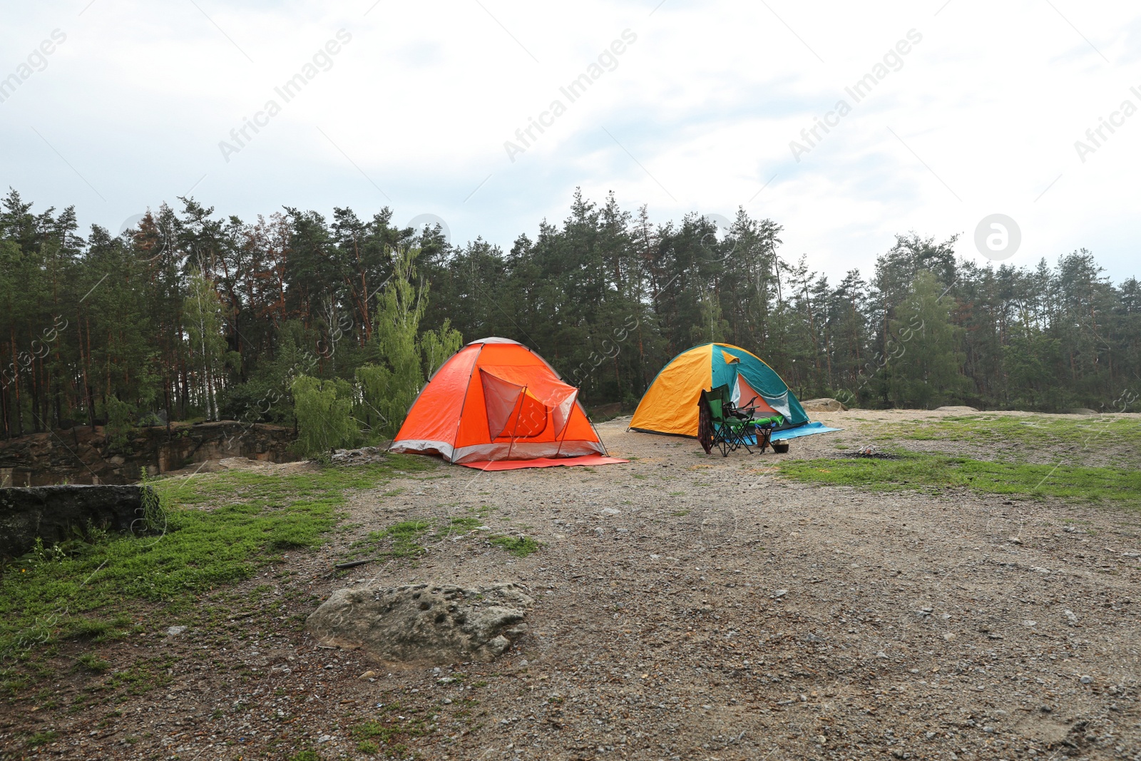 Photo of Camping tents and accessories in wilderness near forest