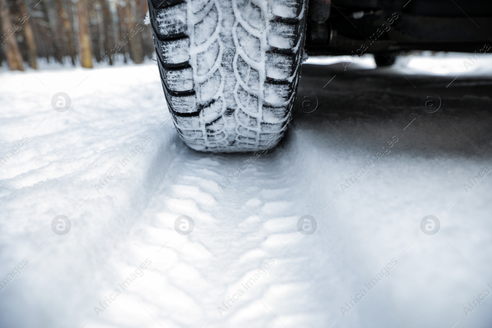 Photo of Car on snowy road, closeup. Winter season