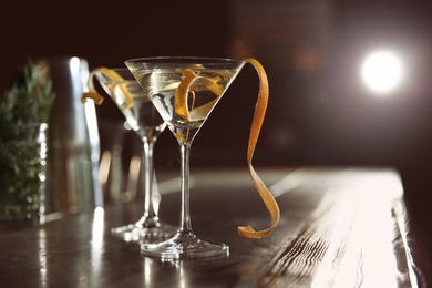 Photo of Glasses of lemon drop martini cocktail in bar. Space for text