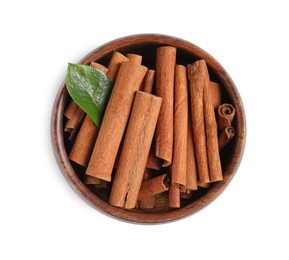 Photo of Cinnamon sticks and green leaf in bowl isolated on white, top view