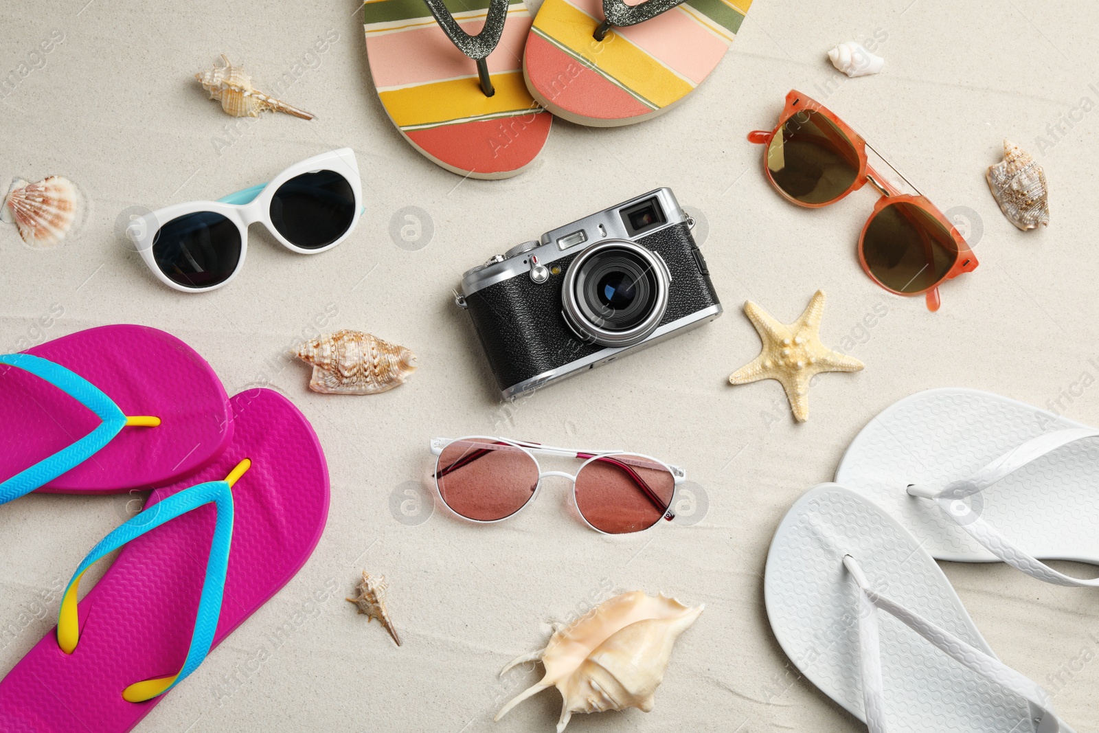 Photo of Flat lay composition with beach accessories on sand