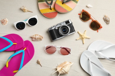 Flat lay composition with beach accessories on sand