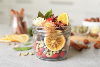 Aromatic potpourri in glass jar on light table
