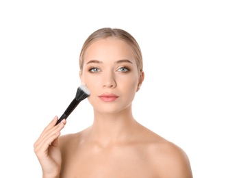 Photo of Portrait of beautiful young woman with makeup brush on white background