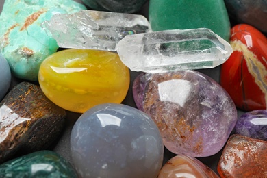 Photo of Different precious gemstones as background, closeup view