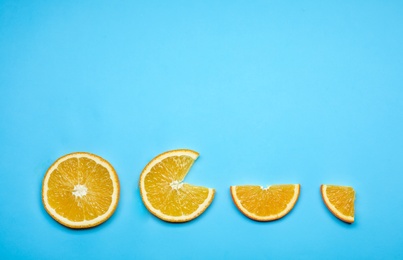 Composition with fresh orange slices and space for text on color background, flat lay