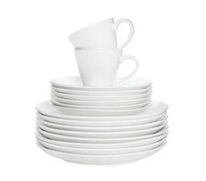 Stacked plates and cups on white background