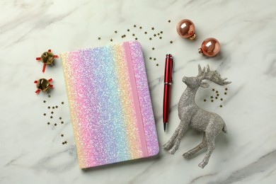 Photo of Stylish planner and Christmas decor on white marble background, flat lay. New Year aims