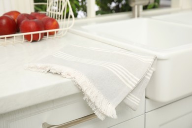Photo of Clean towel near white sink in kitchen