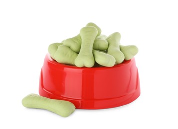 Photo of Bone shaped dog cookies and feeding bowl on white background