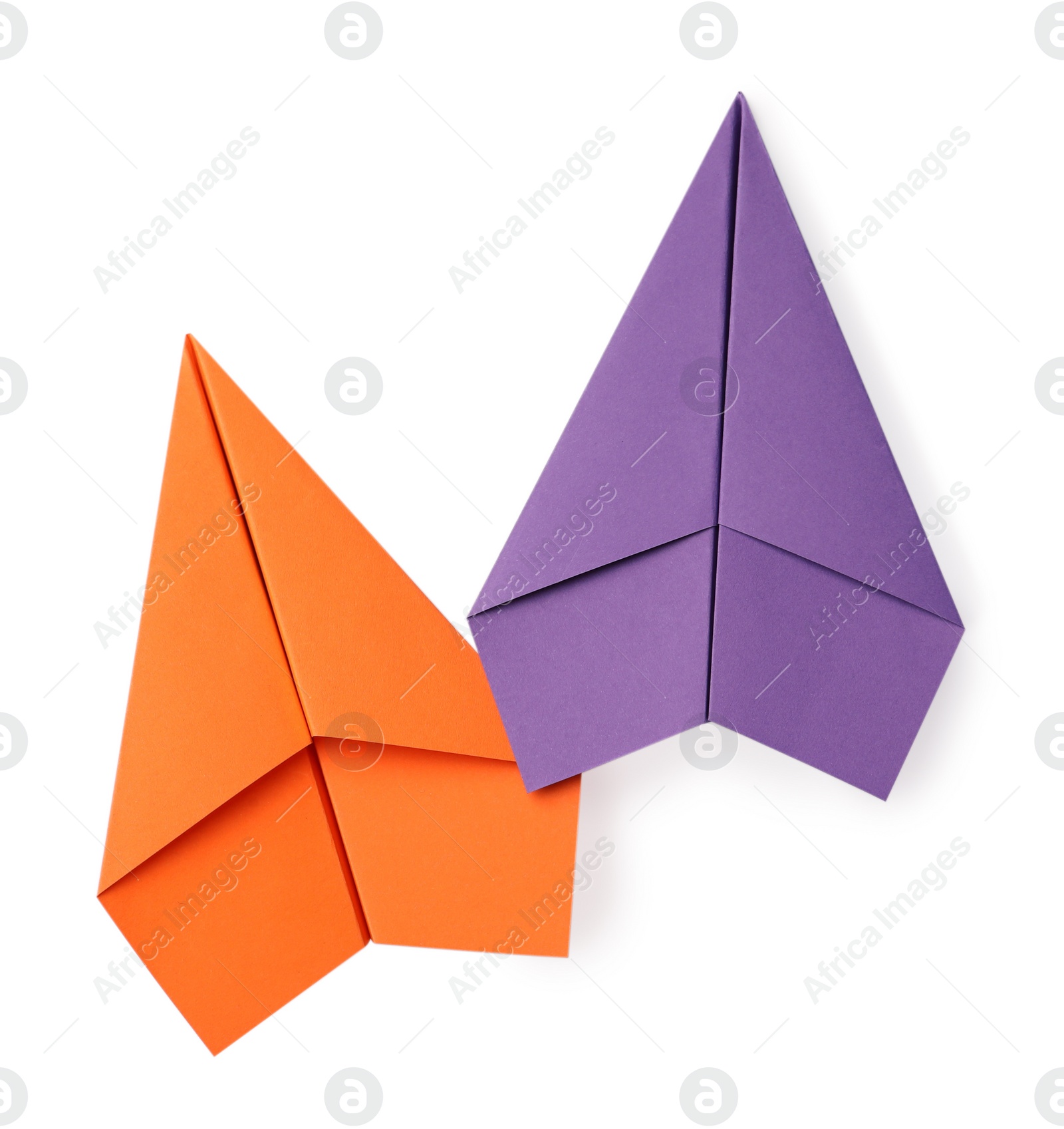 Photo of Handmade orange and purple paper planes isolated on white, top view