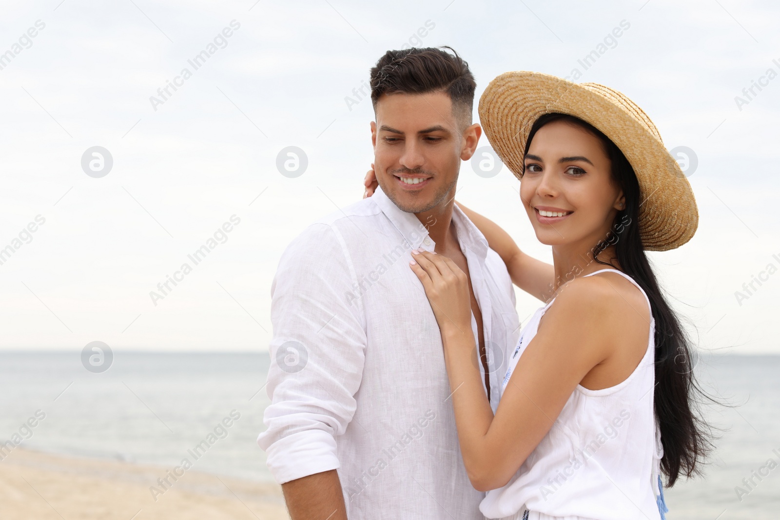 Photo of Lovely couple spending time together on beach