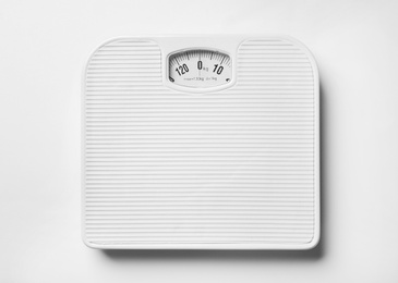 Bathroom scales on white background, top view. Weight loss concept