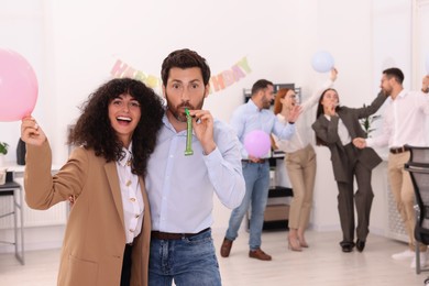 Photo of Coworkers having fun during office party indoors, space for text