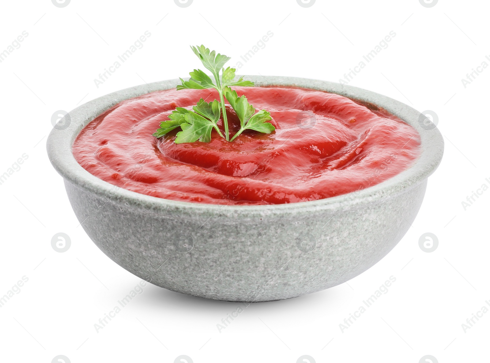 Photo of Tasty ketchup with parsley in bowl isolated on white. Tomato sauce