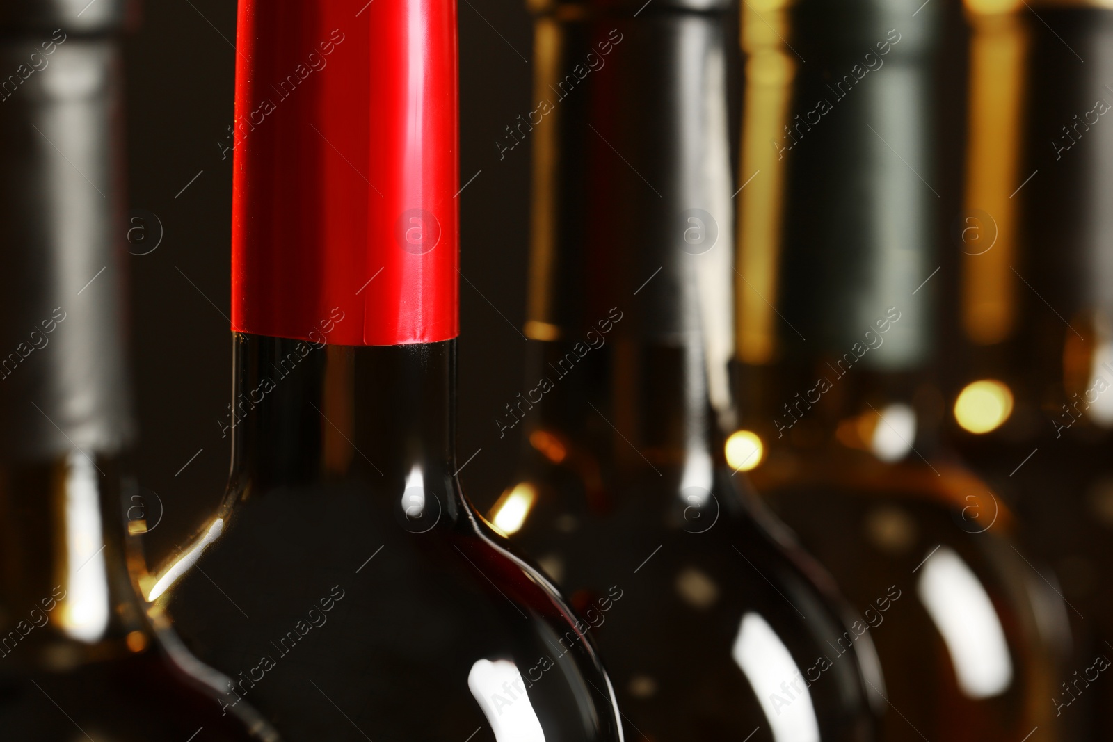 Photo of Bottles of different wines, closeup. Expensive collection