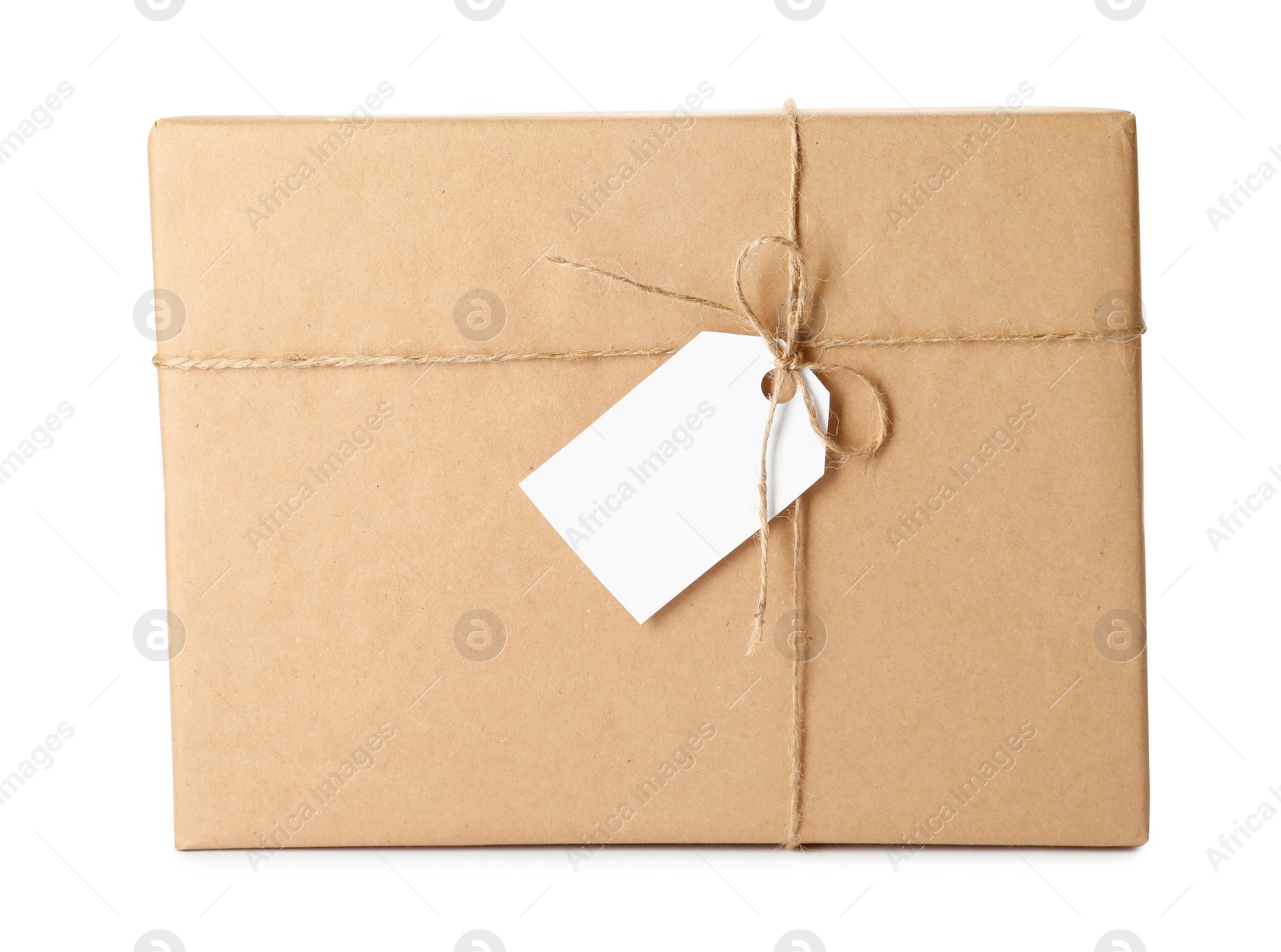 Photo of Gift box wrapped in kraft paper with bow and tag isolated on white