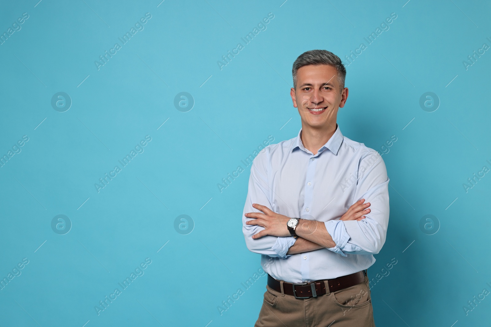 Photo of Portrait of happy man on light blue background, space for text