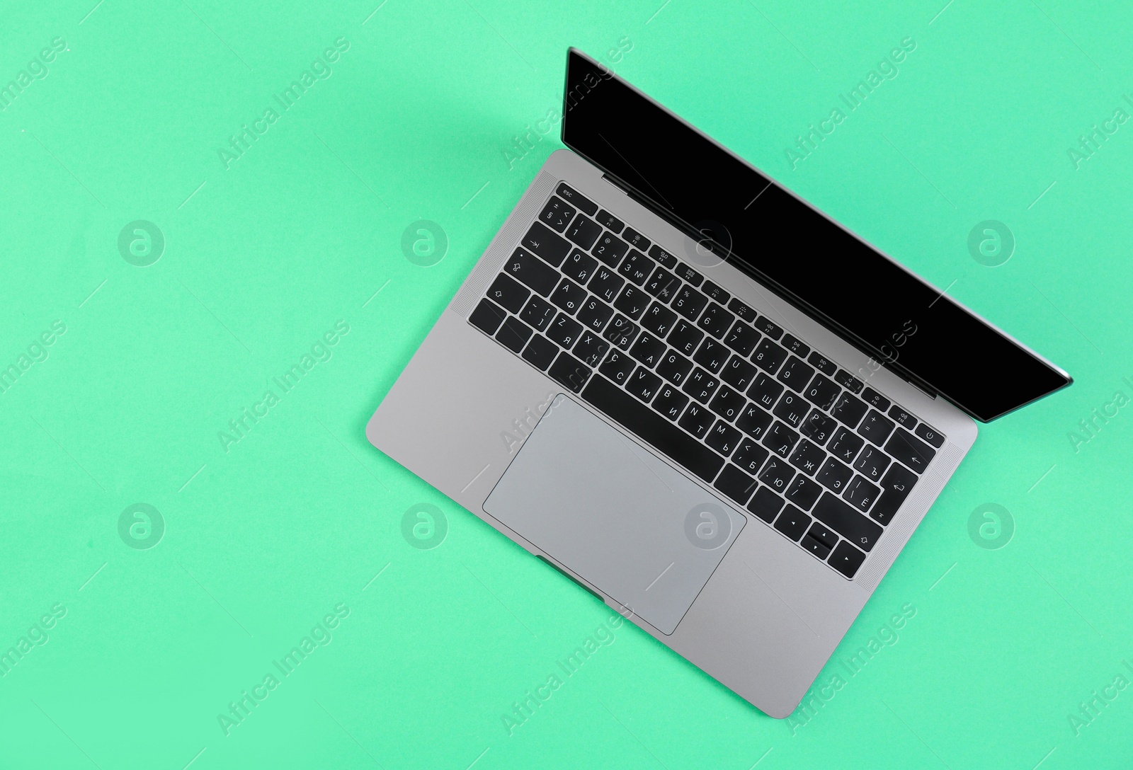 Photo of Modern laptop on color background, top view