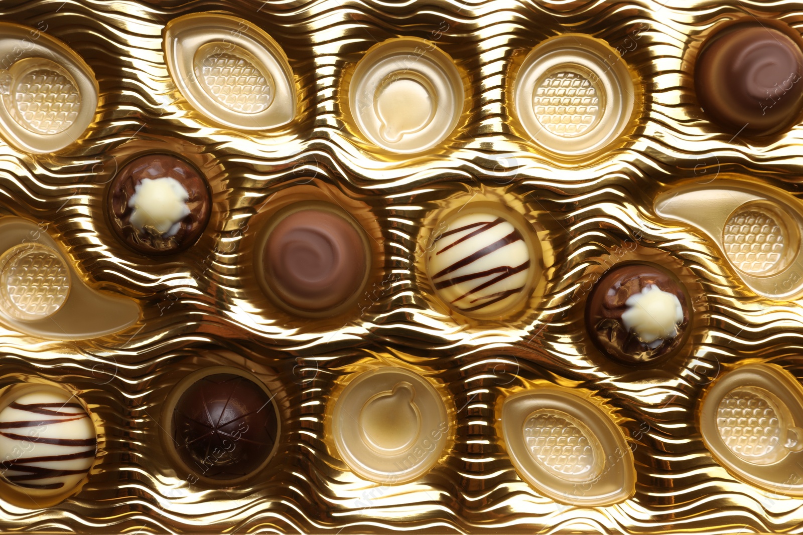 Photo of Partially empty box of chocolate candies as background, top view