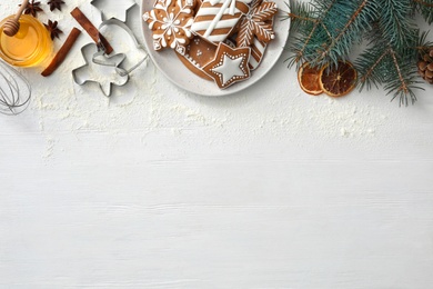 Flat lay composition with delicious homemade Christmas cookies on white wooden table. Space for text