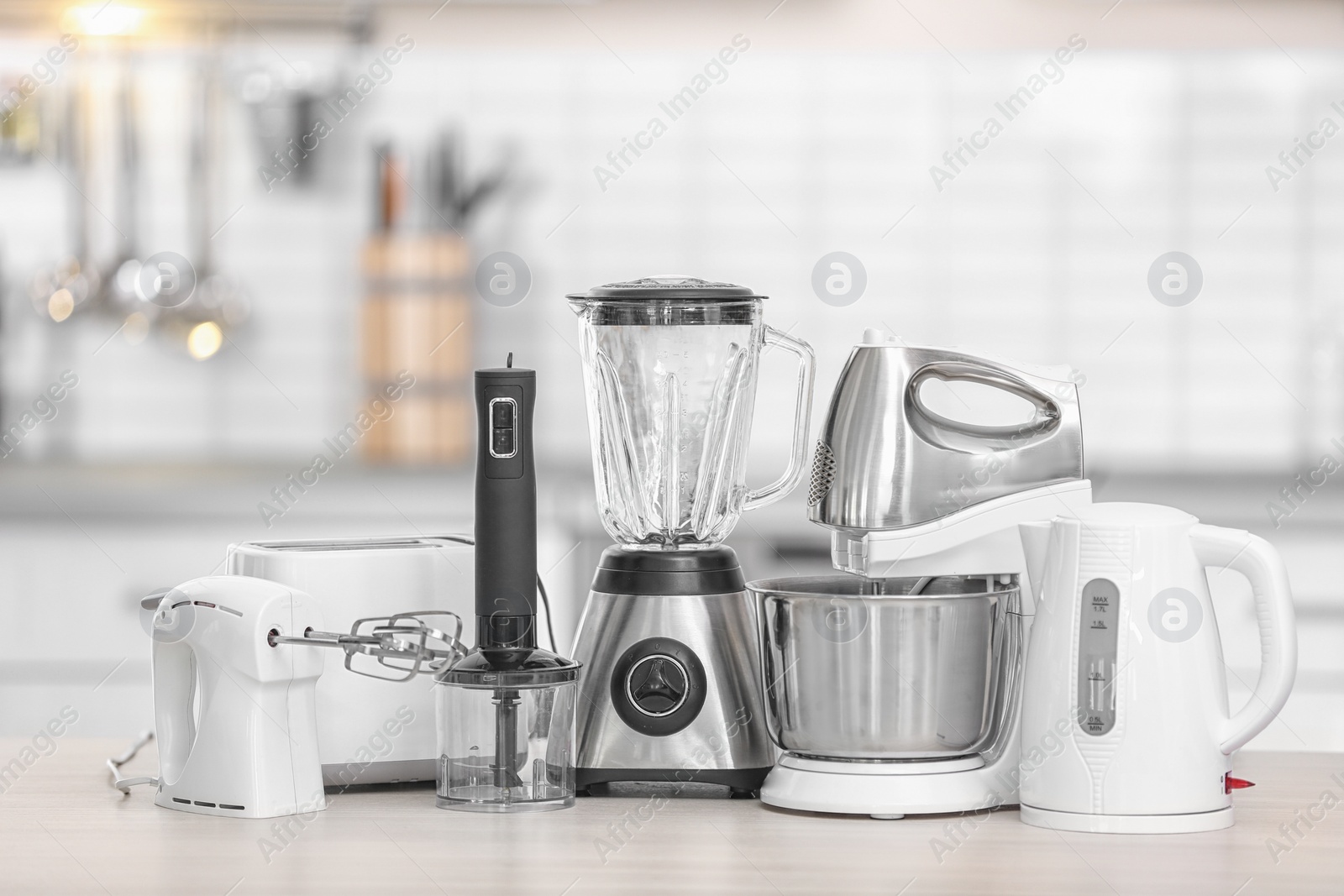 Photo of Different modern kitchen appliances on table indoors. Interior element